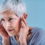 Senior Woman Suffering From Tinnitus